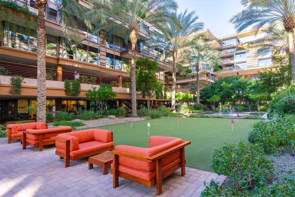 Putting green and lounge seating in the Optima Camelview courtyard