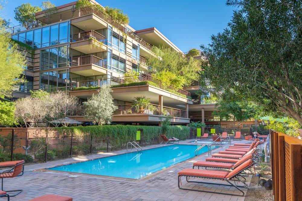 Outdoor pool and lounge chairs at Optima Camelview